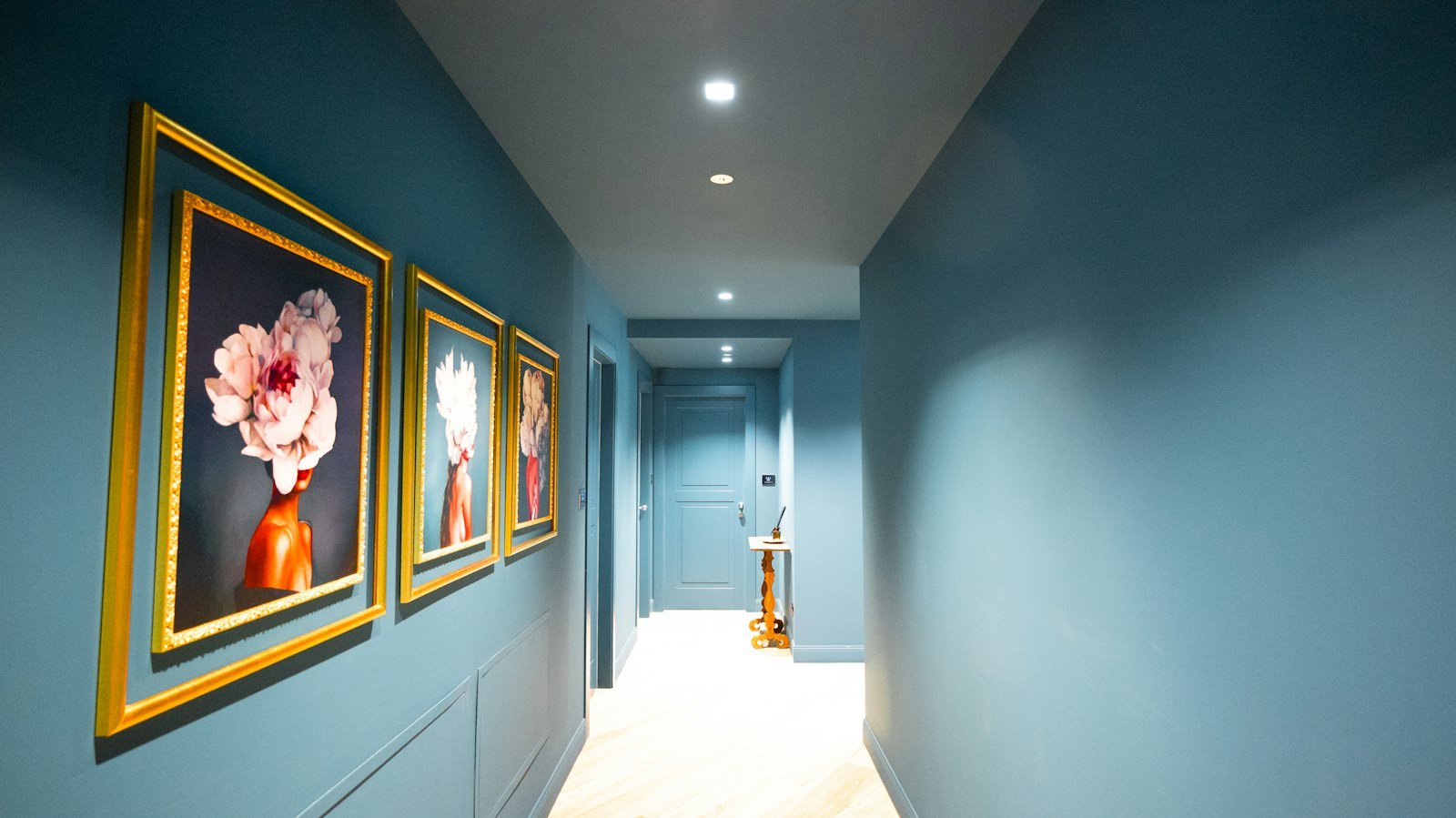 Freshly painted blue hallway with framed artwork
