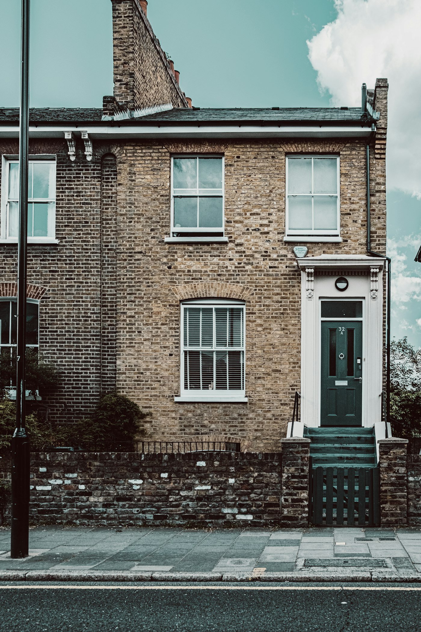 London brick terraced house with a painted front door